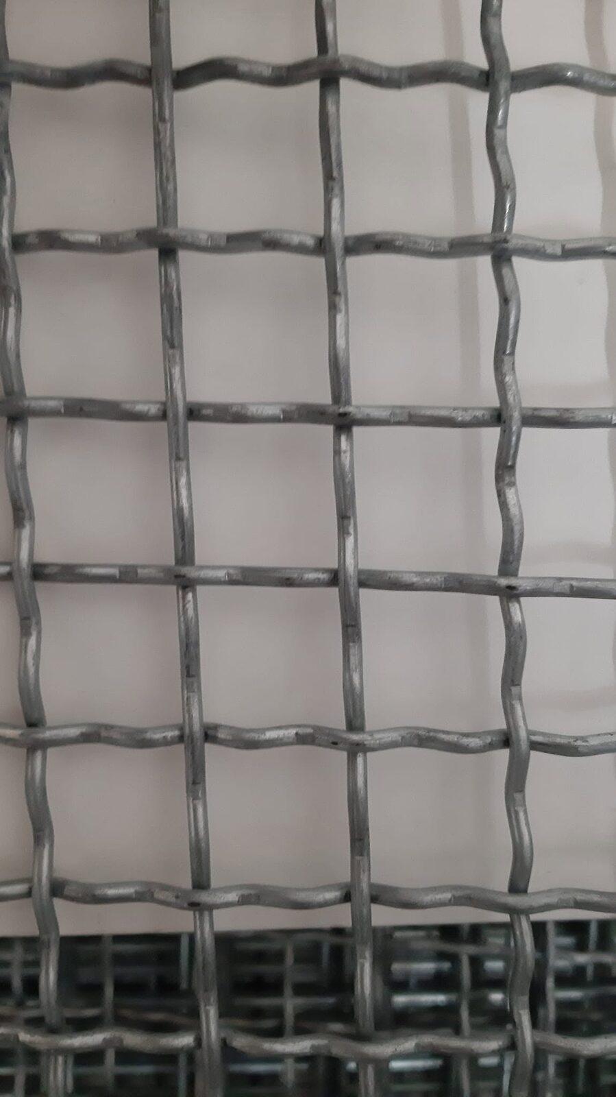 Cut panel of woven steel mesh